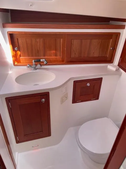 Slide: The Image of 2023 MJM 35z yacht bathroom with wooden cabinets and modern fixtures. - 33