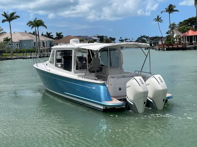 Slide: The Image of 2023 MJM 35z boat with twin outboard engines on a sunny day. - 4
