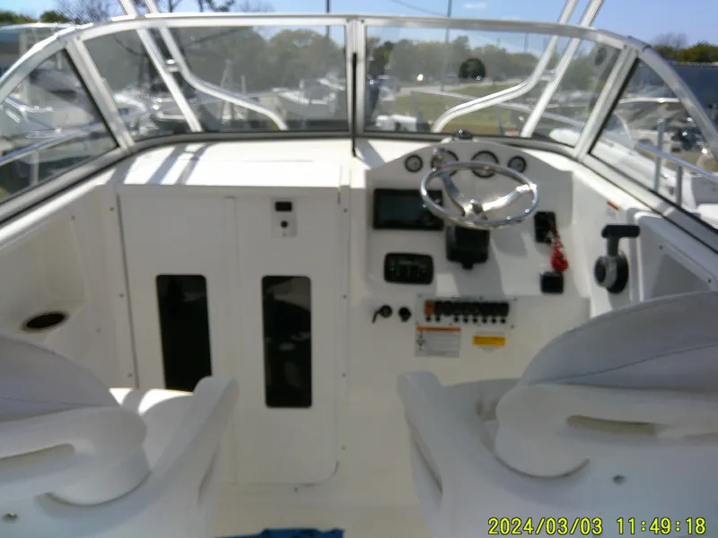 Slide: The Image of 2013 Sea Fox 236 Voyager boat cockpit with steering wheel and control panel. - 10