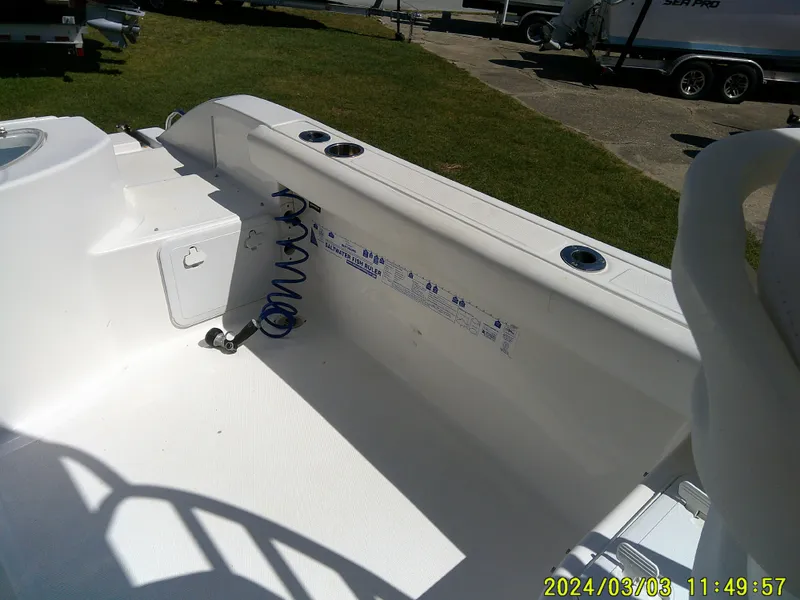 Slide: The Image of 2013 Sea Fox 236 Voyager boat interior with clean white deck and coiled hose. - 14
