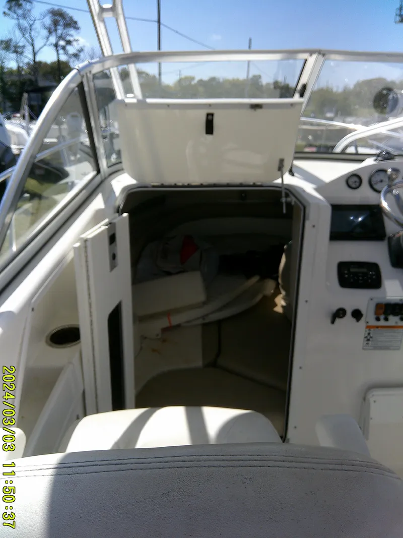 Slide: The Image of 2013 Sea Fox 236 Voyager boat interior with open cabin door and dashboard view. - 15