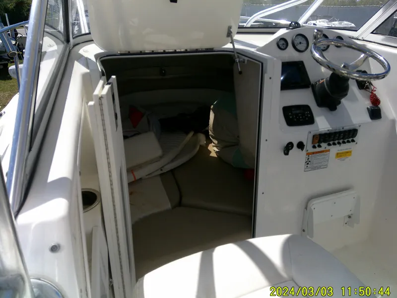 Slide: The Image of 2013 Sea Fox 236 Voyager boat interior with cabin and control panel. - 16