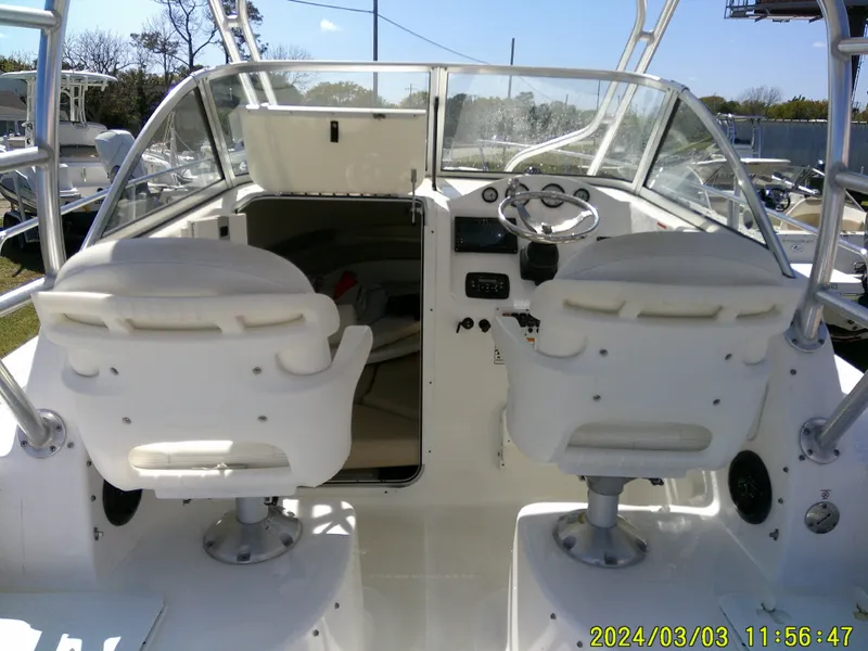 Slide: The Image of 2013 Sea Fox 236 Voyager boat interior with dual captain chairs and steering console. - 19