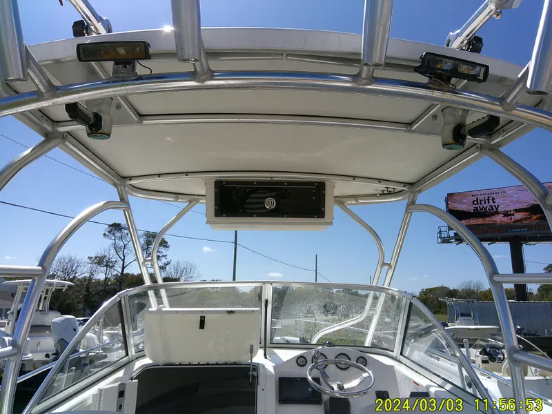 Slide: The Image of 2013 Sea Fox 236 Voyager boat interior with steering wheel and overhead console. - 20