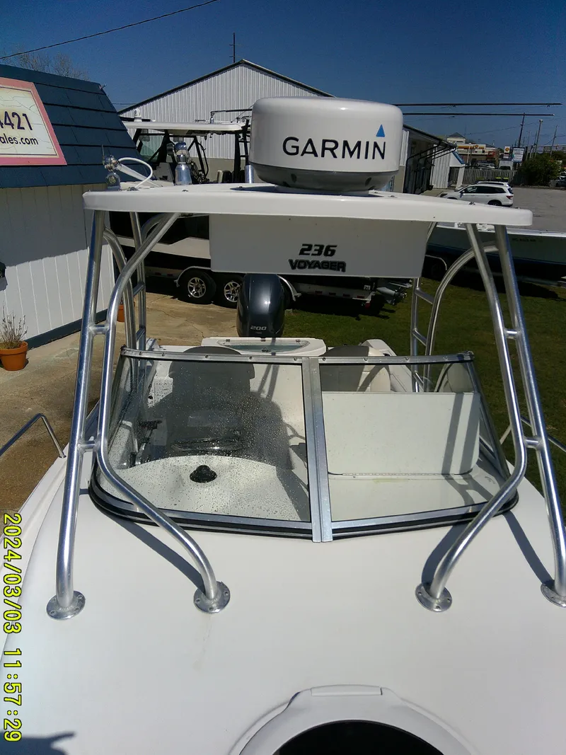 Slide: The Image of 2013 Sea Fox 236 Voyager boat with Garmin radar, docked outdoors. - 23