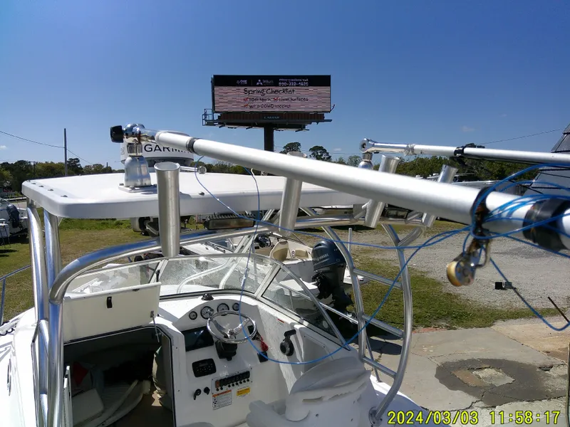 Slide: The Image of Sea Fox 236 Voyager boat with fishing rods and Garmin equipment, captured on a sunny day. - 28