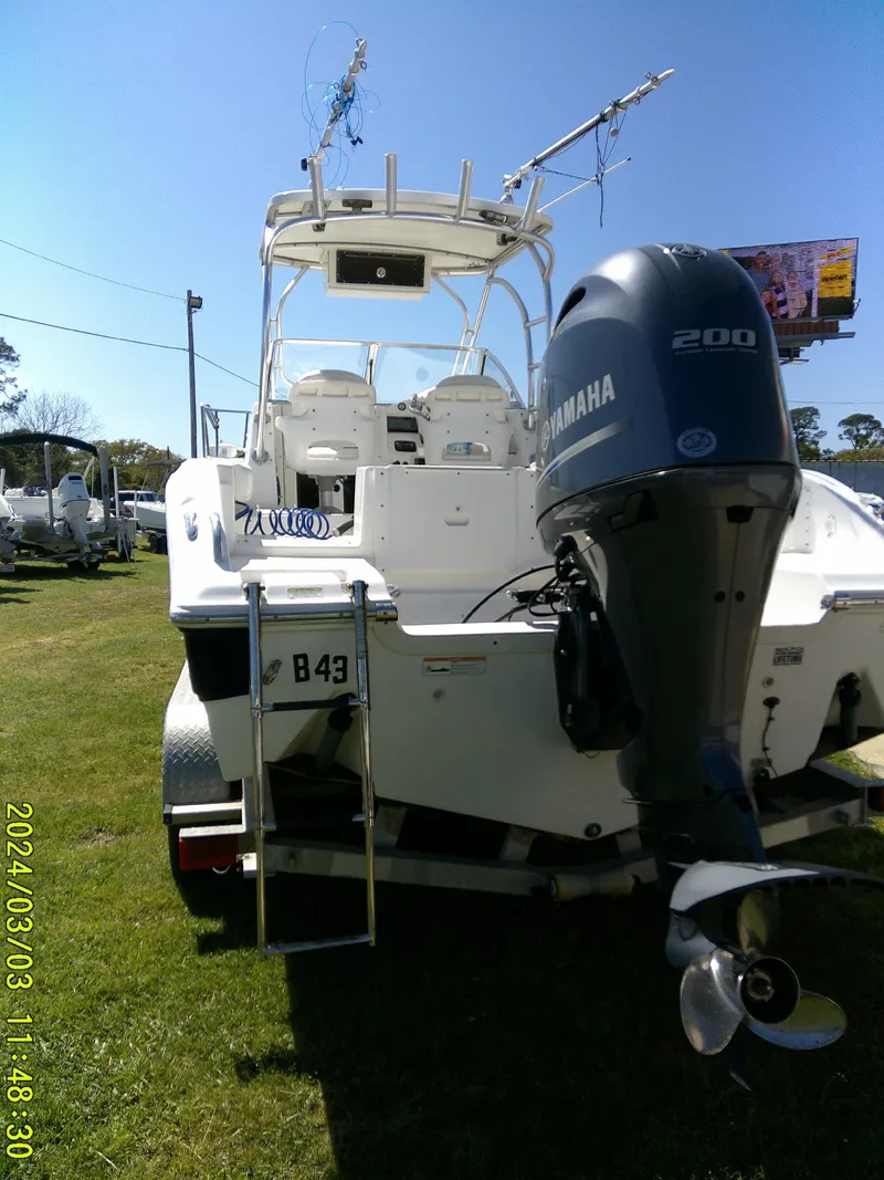 Slide: The Image of 2013 Sea Fox 236 Voyager boat with Yamaha 200 engine, parked on grass. - 9