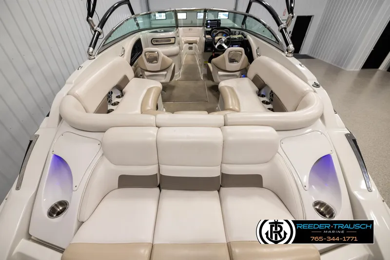 Slide: The Image of 2014 Crownline 255 SS boat interior with beige seating and modern dashboard. - 12