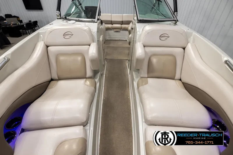 Slide: The Image of 2014 Crownline 255 SS boat interior with beige seating and blue accent lighting. - 16