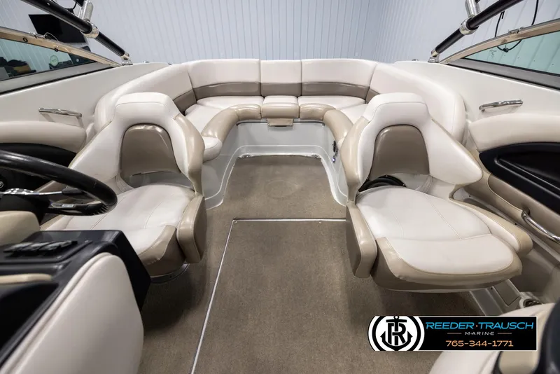 Slide: The Image of Interior of a 2014 Crownline 255 SS boat with beige seating and carpet. - 17