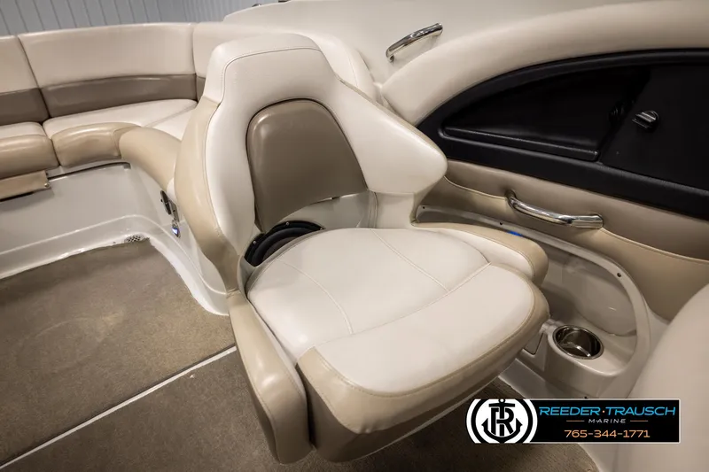 Slide: The Image of 2014 Crownline 255 SS boat interior with beige seating and cup holder. - 19