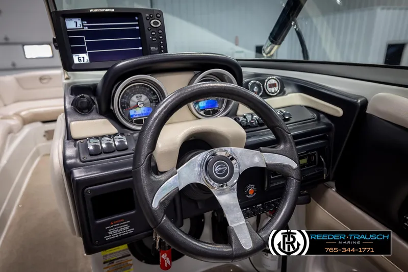 Slide: The Image of 2014 Crownline 255 SS boat dashboard with steering wheel and navigation display. - 25