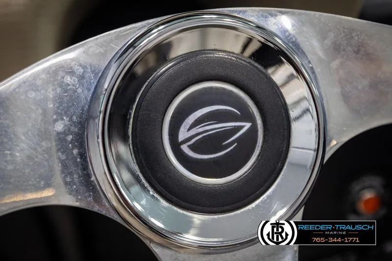 Slide: The Image of Steering wheel of 2014 Crownline 255 SS boat with logo and Reeder-Trausch Marine branding. - 26