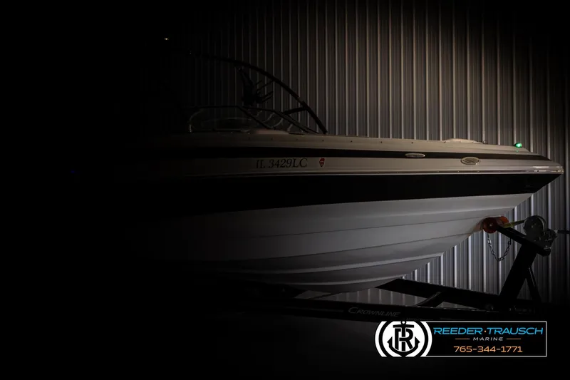 Slide: The Image of 2014 Crownline 255 SS boat in dimly lit storage, side view. - 3
