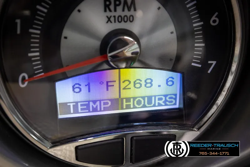 Slide: The Image of Close-up of 2014 Crownline 255 SS RPM gauge displaying temperature and hours. - 30