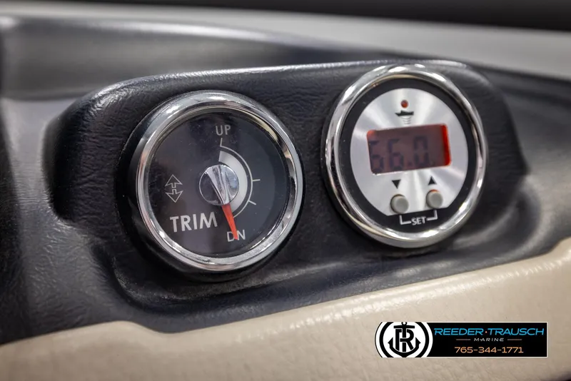 Slide: The Image of 2014 Crownline 255 SS boat dashboard with trim gauge and digital display. - 31