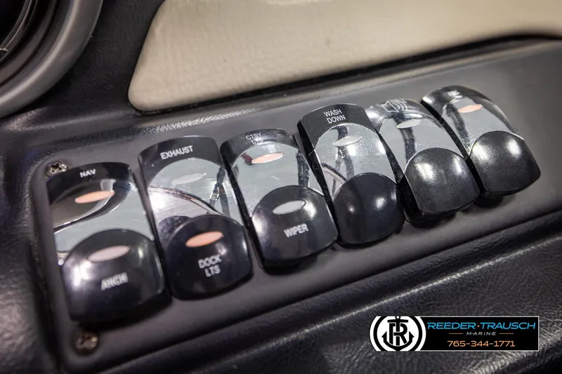 Slide: The Image of Control panel switches on a 2014 Crownline 255 SS boat dashboard. - 32