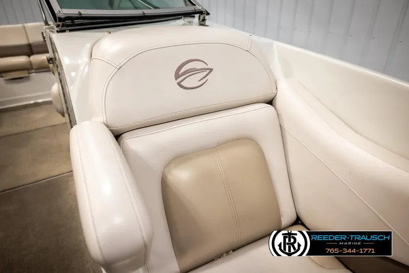Slide: The Image of 2014 Crownline 255 SS boat interior with beige seating and logo. - 38