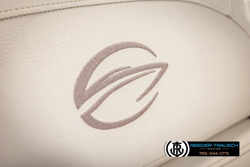 Slide: The Image of Crownline 255 SS 2014 logo on white leather upholstery, Reeder-Trausch Marine branding. - 39