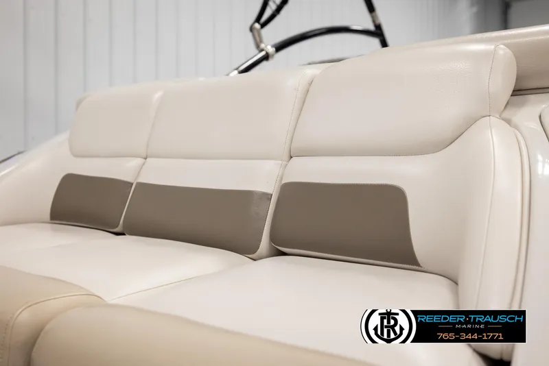 Slide: The Image of 2014 Crownline 255 SS boat interior seating, beige and brown upholstery, Reeder-Trausch Marine logo. - 40