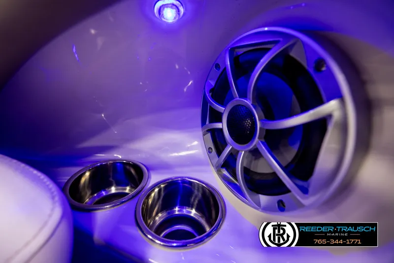 Slide: The Image of 2014 Crownline 255 SS boat interior with speaker, cup holders, and blue LED lighting. - 41