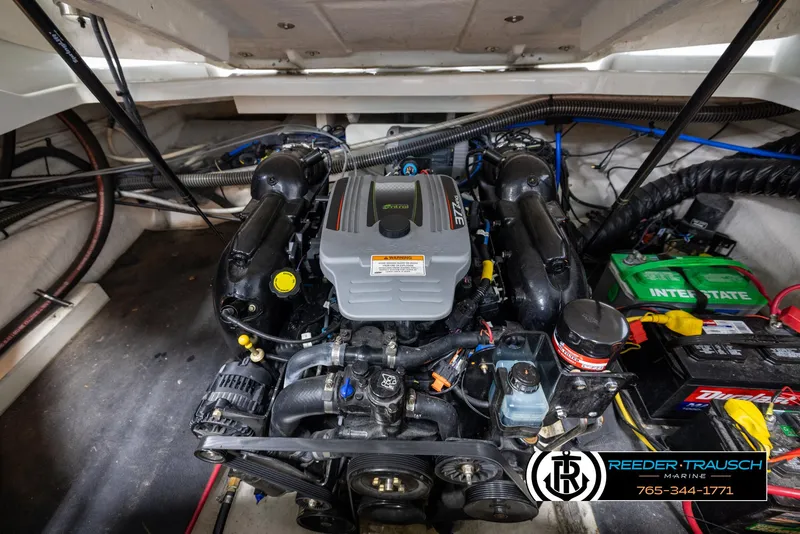 Slide: The Image of Engine compartment of a 2014 Crownline 255 SS boat, featuring a powerful motor. - 45