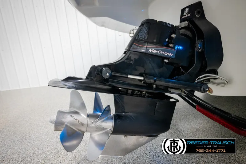 Slide: The Image of 2014 Crownline 255 SS boat with MerCruiser engine and propeller, displayed indoors. - 47