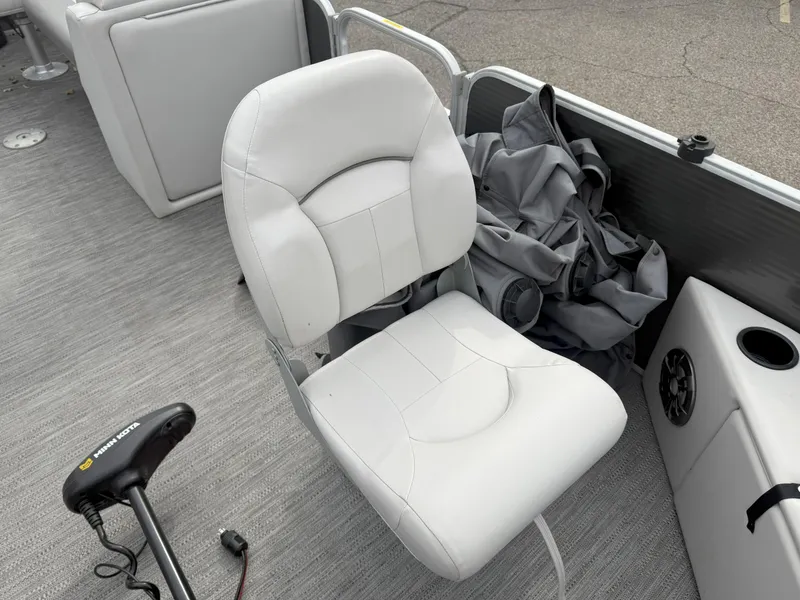 Slide: The Image of White seat on 2022 Godfrey Sweetwater 1886 FX boat with gray flooring and accessories. - 10