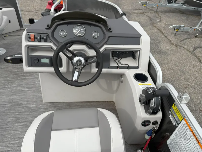 Slide: The Image of Steering console of 2022 Godfrey Sweetwater 1886 FX boat with modern controls and seating. - 12