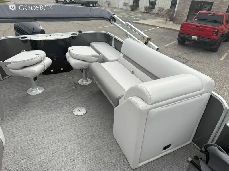 Slide: The Image of 2022 Godfrey Sweetwater 1886 FX pontoon boat with white seating and modern design. - 13