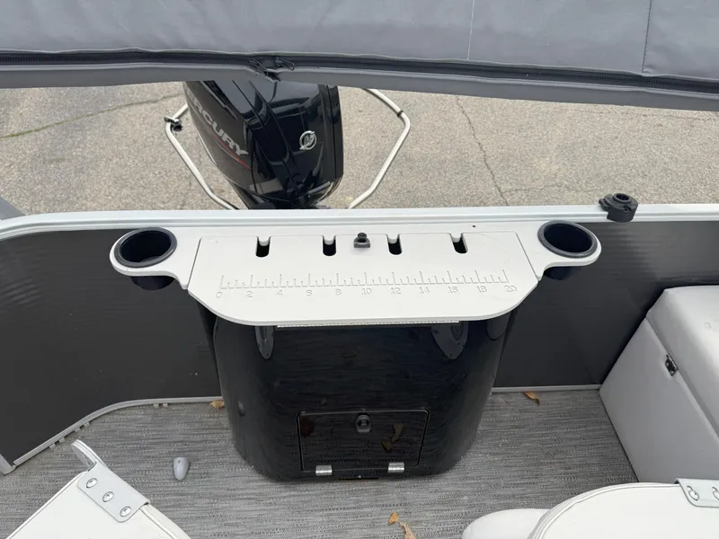 Slide: The Image of 2022 Godfrey Sweetwater 1886 FX boat interior with motor and fishing rod holders. - 15