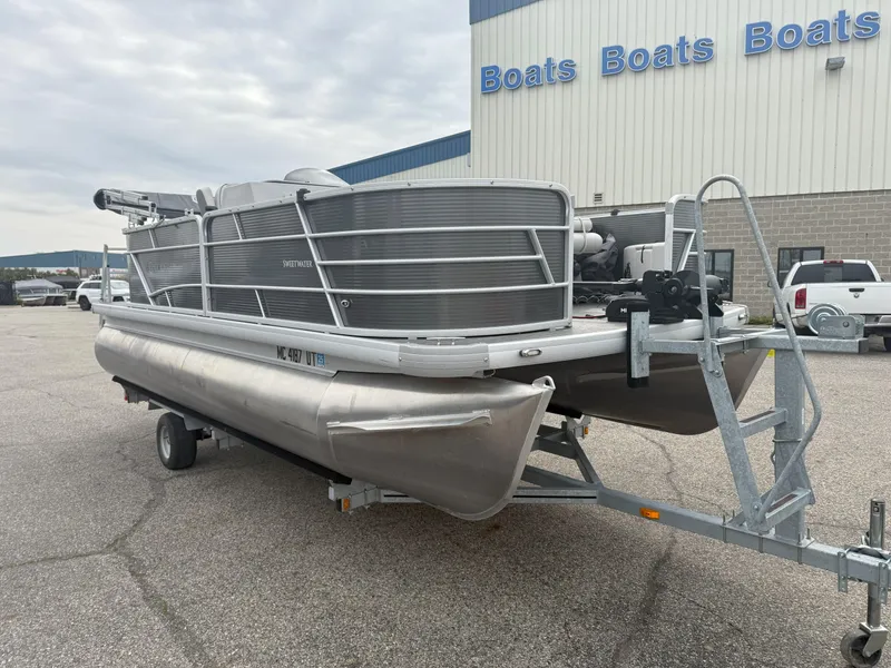 Slide: The Image of 2022 Godfrey Sweetwater 1886 FX pontoon boat on trailer outside dealership. - 3