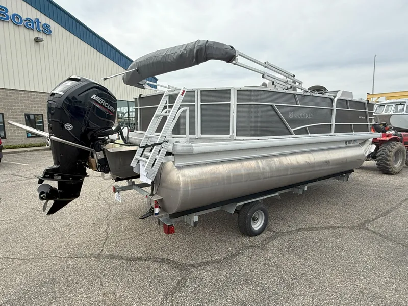 Slide: The Image of 2022 Godfrey Sweetwater 1886 FX pontoon boat on trailer, parked outside a building. - 4