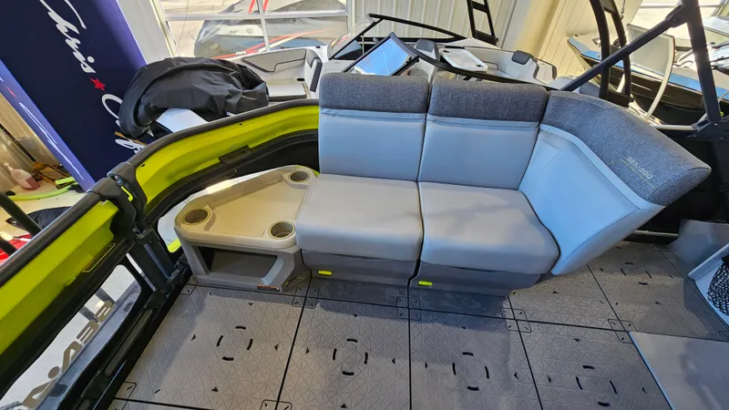 Slide: The Image of 2023 Sea-Doo Switch Cruise 21 interior seating with cup holders and modern design. - 11
