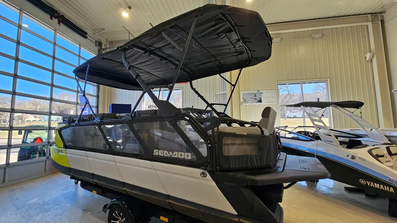 Slide: The Image of 2023 Sea-Doo Switch Cruise 21 pontoon boat displayed indoors with canopy. - 2