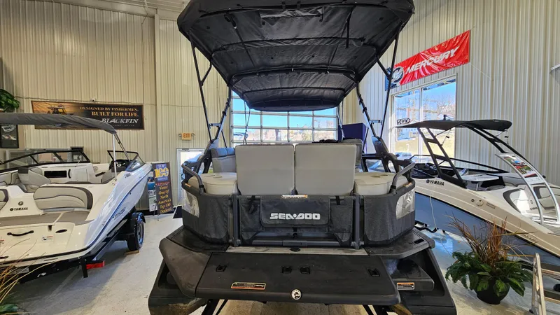 Slide: The Image of 2023 Sea-Doo Switch Cruise 21 pontoon boat displayed in a showroom. - 4