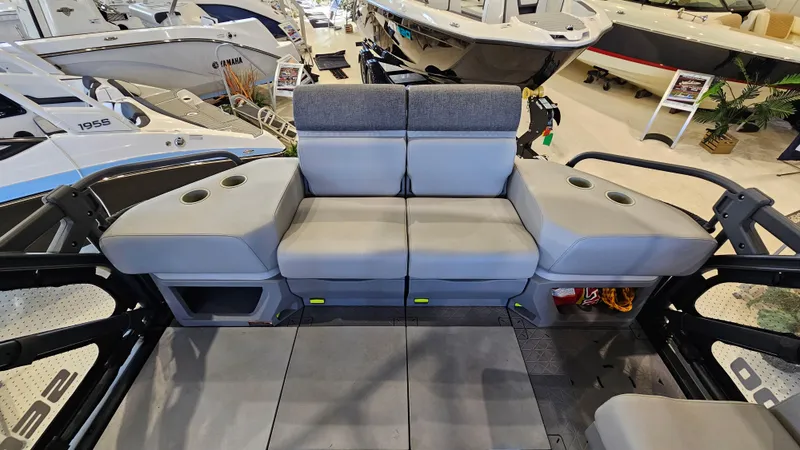Slide: The Image of 2023 Sea-Doo Switch Cruise 21 interior seating with cup holders in a showroom. - 8
