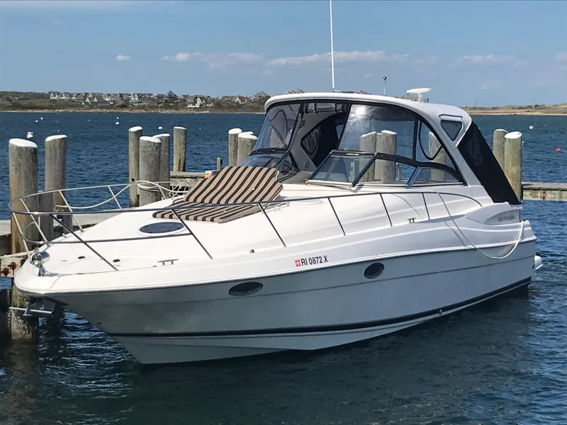 Slide: The Image of 2007 Regal Commodore 3760 IB yacht docked in a serene marina setting. - 0