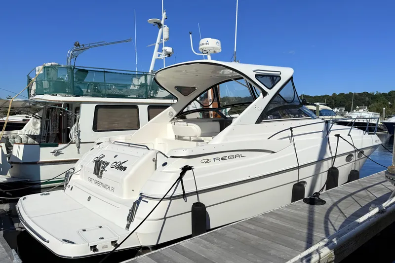 Slide: The Image of 2007 Regal Commodore 3760 IB yacht docked at marina under clear blue sky. - 1