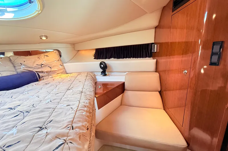 Slide: The Image of Luxurious cabin interior of 2007 Regal Commodore 3760 IB yacht, featuring elegant bedding and seating. - 19