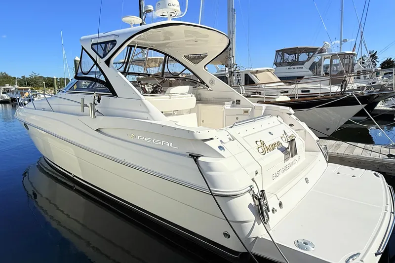 Slide: The Image of 2007 Regal Commodore 3760 IB yacht docked at marina, showcasing sleek design and luxury features. - 4