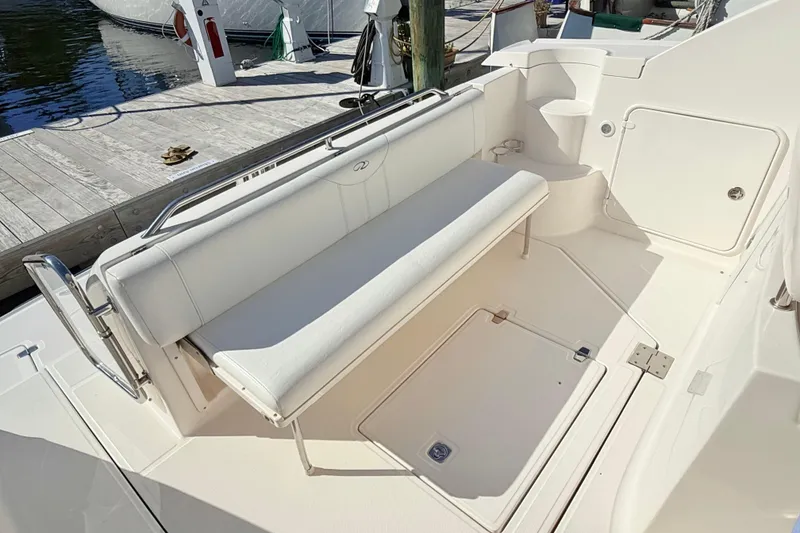 Slide: The Image of 2007 Regal Commodore 3760 IB boat interior with white seating and dock view. - 7