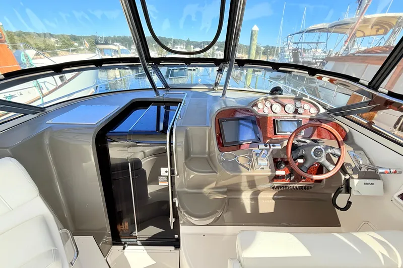 Slide: The Image of 2007 Regal Commodore 3760 IB helm with modern controls and wood-accented steering wheel. - 8