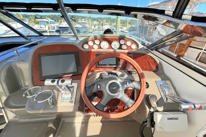 Slide: The Image of 2007 Regal Commodore 3760 IB helm with wood accents and modern navigation equipment. - 9
