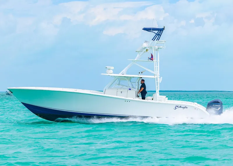 Slide: The Image of 2011 Yellowfin 42 Offshore boat cruising on turquoise waters under a clear sky. - 0