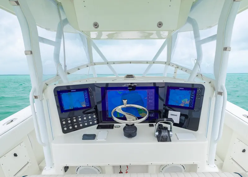 Slide: The Image of 2011 Yellowfin 42 Offshore boat helm with advanced navigation displays and controls. - 12