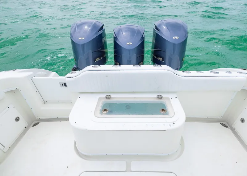 Slide: The Image of 2011 Yellowfin 42 Offshore boat with triple outboard engines on turquoise water. - 15