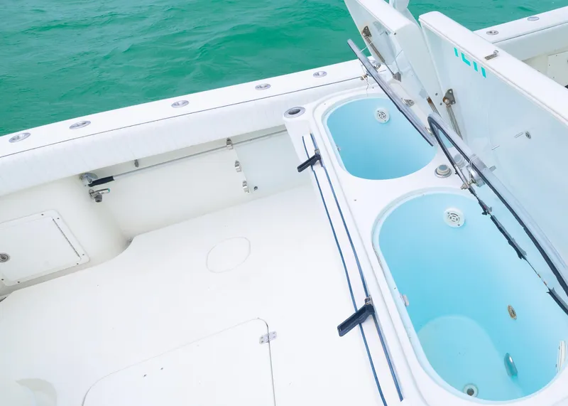 Slide: The Image of 2011 Yellowfin 42 Offshore boat with open storage compartments on deck. - 16