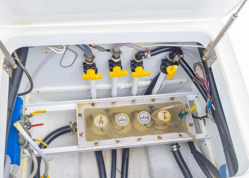 Slide: The Image of 2011 Yellowfin 42 Offshore boat plumbing system with valves and hoses. - 23