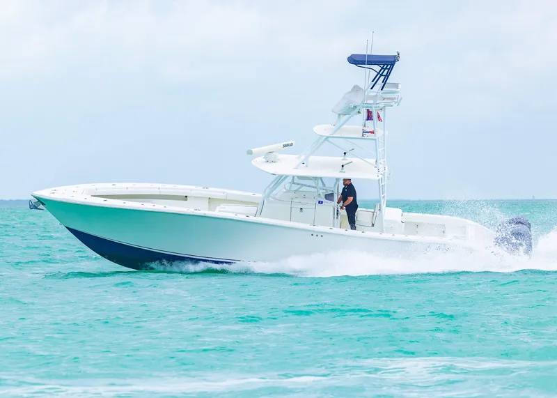Slide: The Image of 2011 Yellowfin 42 Offshore boat cruising on turquoise waters. - 24